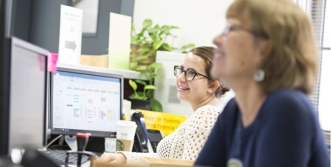 two people looking at computers