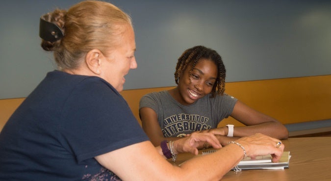 two people looking at a paper