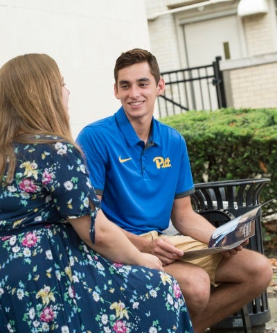 two people talking on a bench