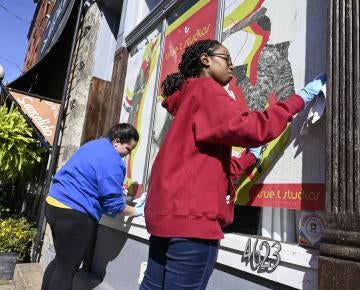 Two students volunteer in the community