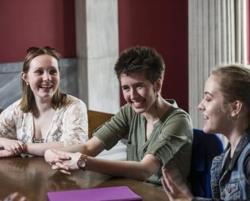 Three students study inside