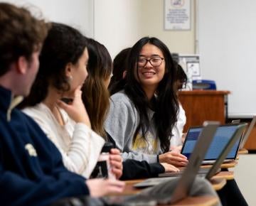 Student discusses course material with peers in class