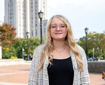 Rachel Clites standing outside in front of the cathedral of learning