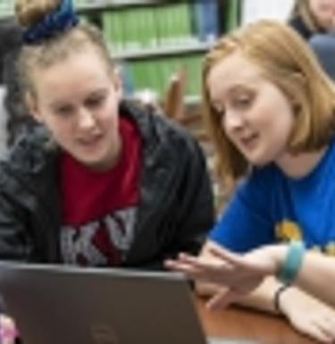 Two people working together at a computer