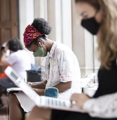 Two student wearing masks study 