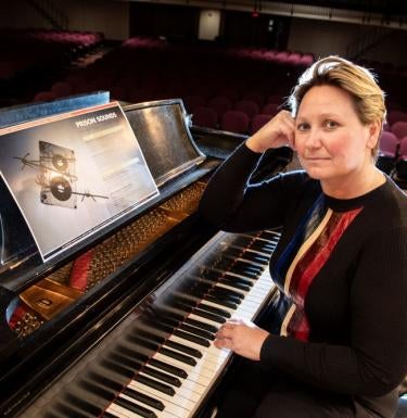 Adriana Helbig seated at a grand piano