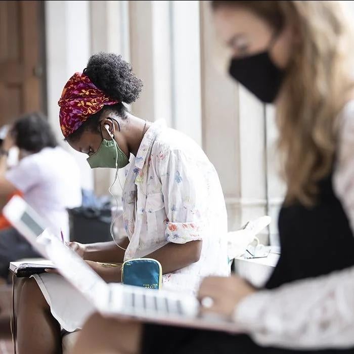 Two student wearing masks study 