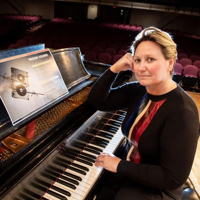 Adriana Helbig seated at a grand piano