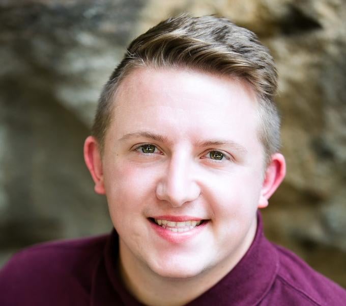 Smiling man with burgundy polo shirt