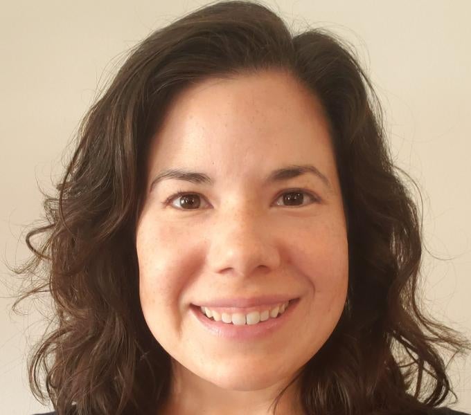 Smiling woman with shoulder-length dark brown hair