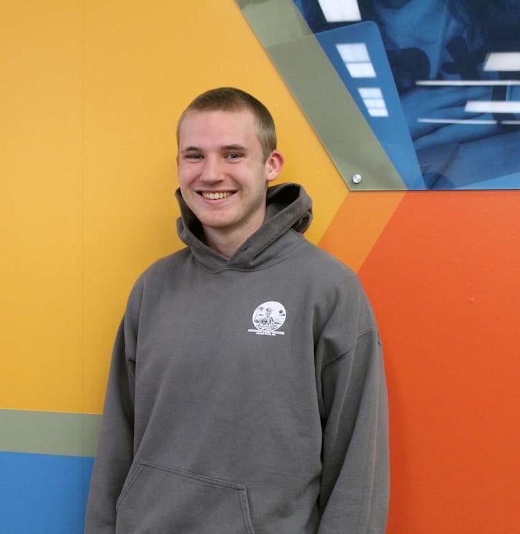 James Smith stands in front of a colorful wall