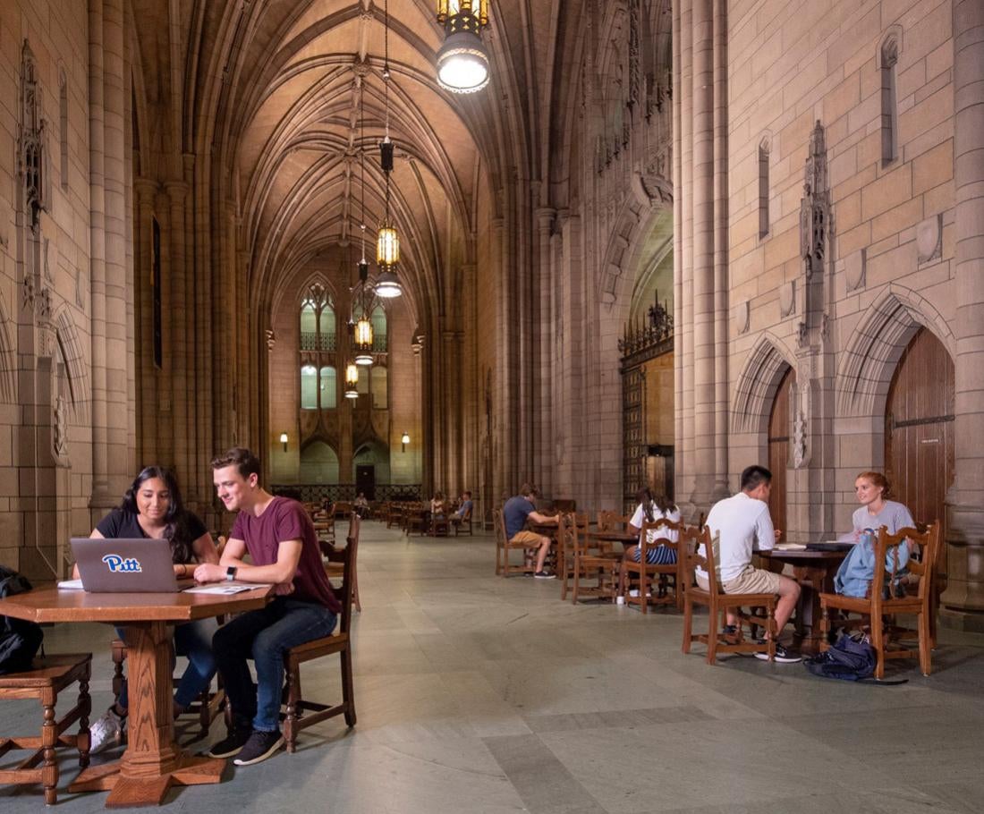 Two students discuss a research project in the Commons Room.