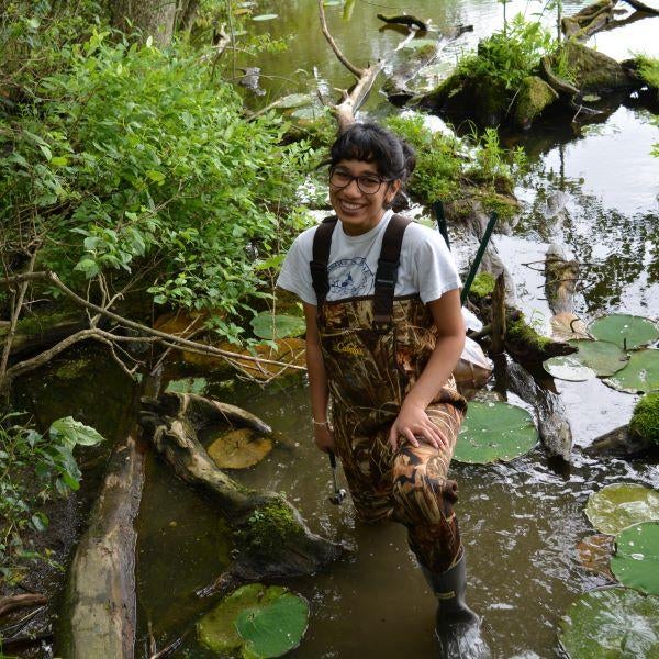 Student stands in a wetland biology lab
